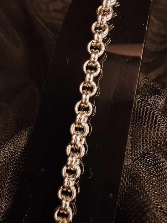 Silver chain on a dark textured background