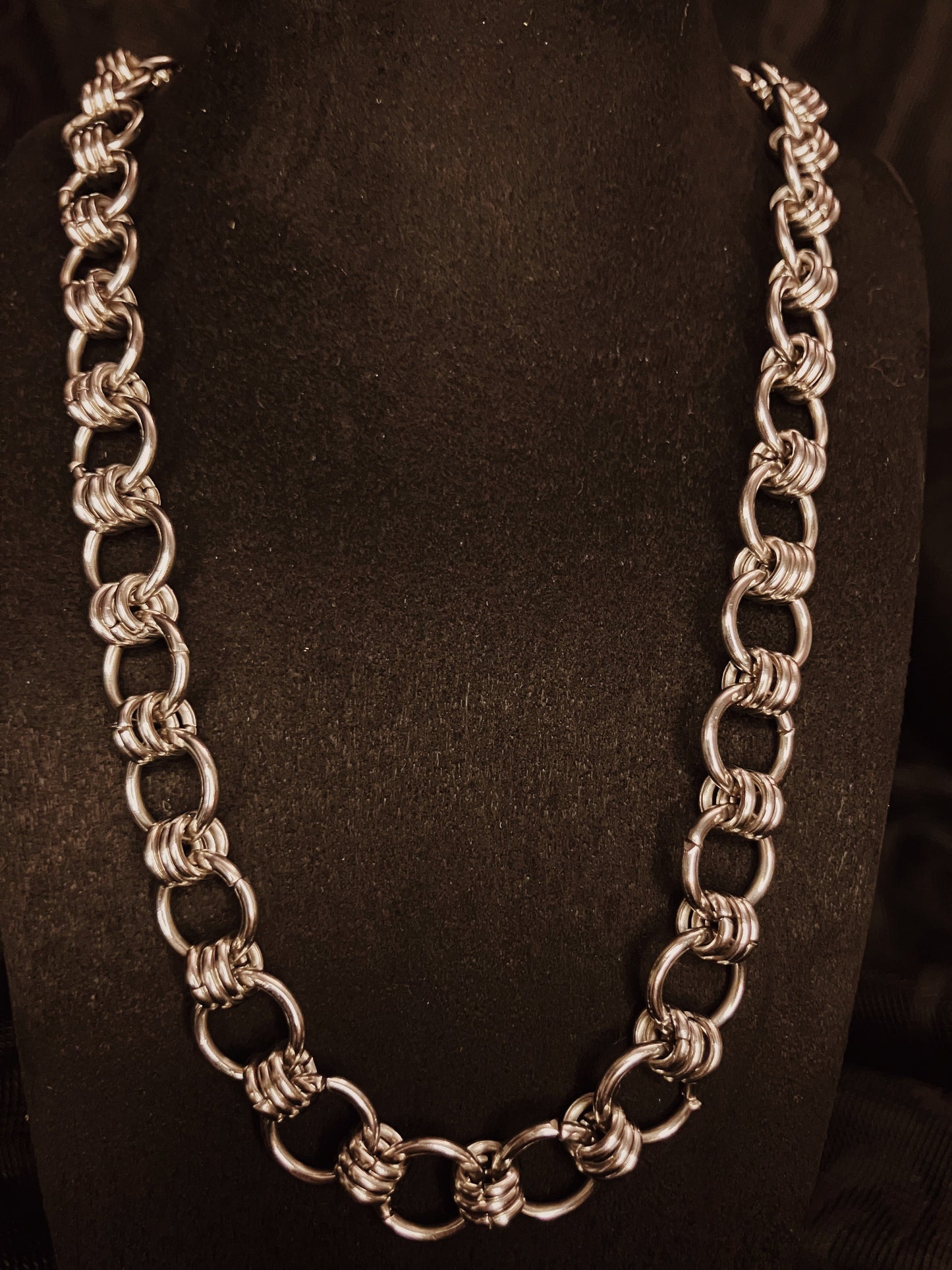 Silver chain necklace on a black background