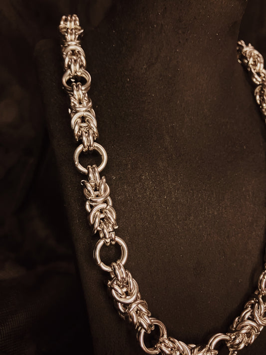 Silver chain necklace on a black background