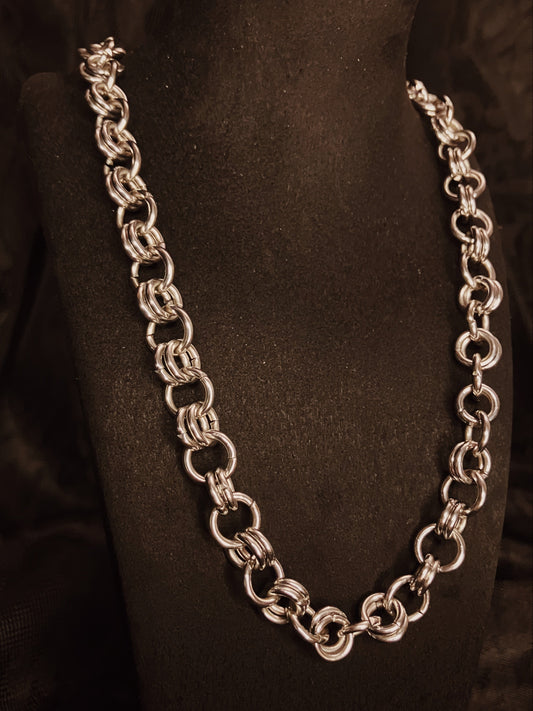 Silver chain necklace on a black mannequin bust