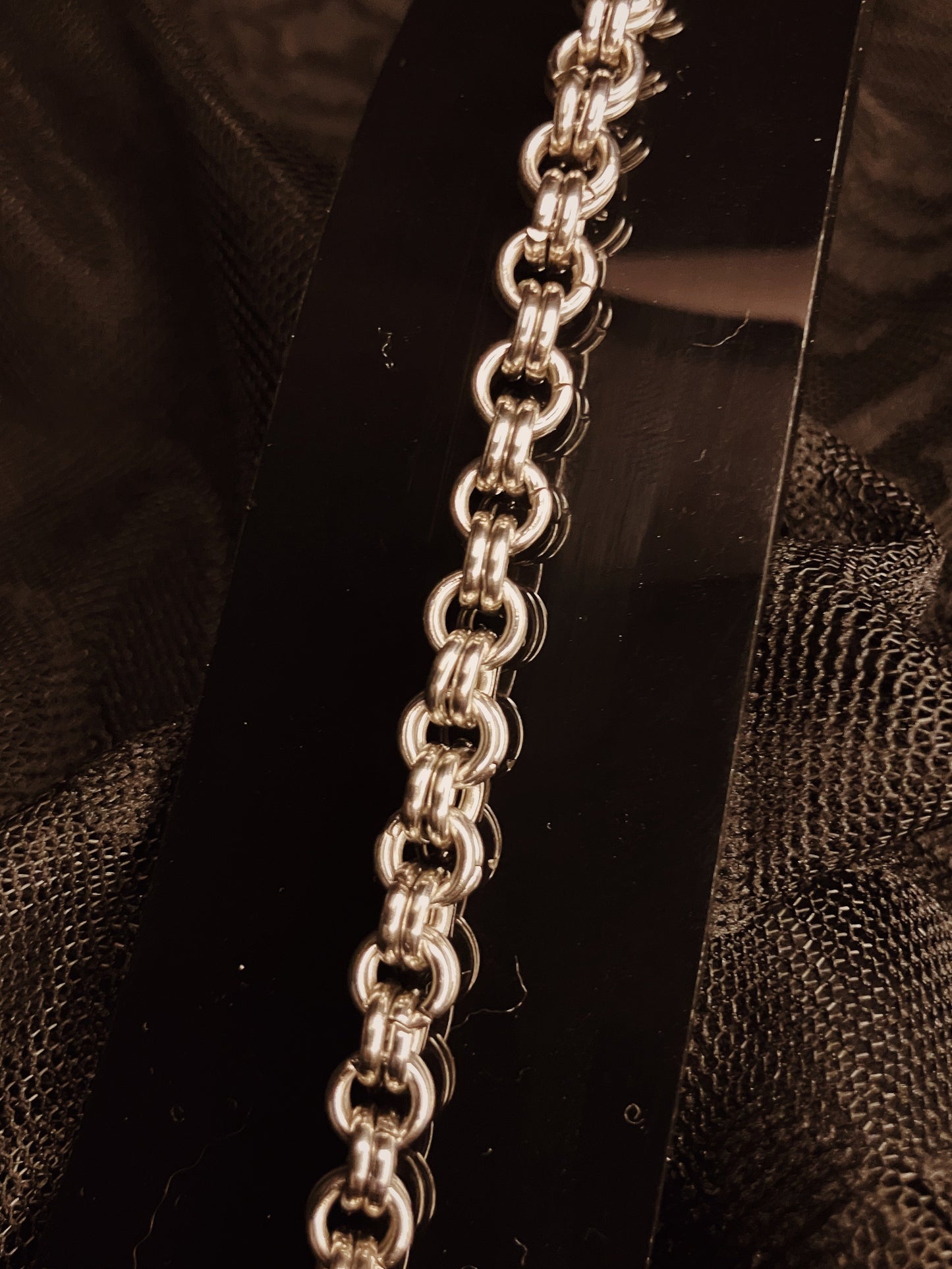 Silver chain on a dark textured background