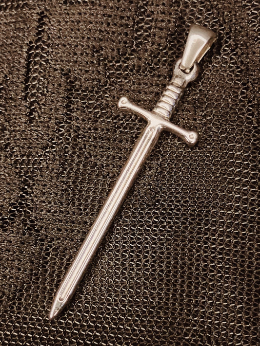 Silver sword-shaped pendant on a textured brown background