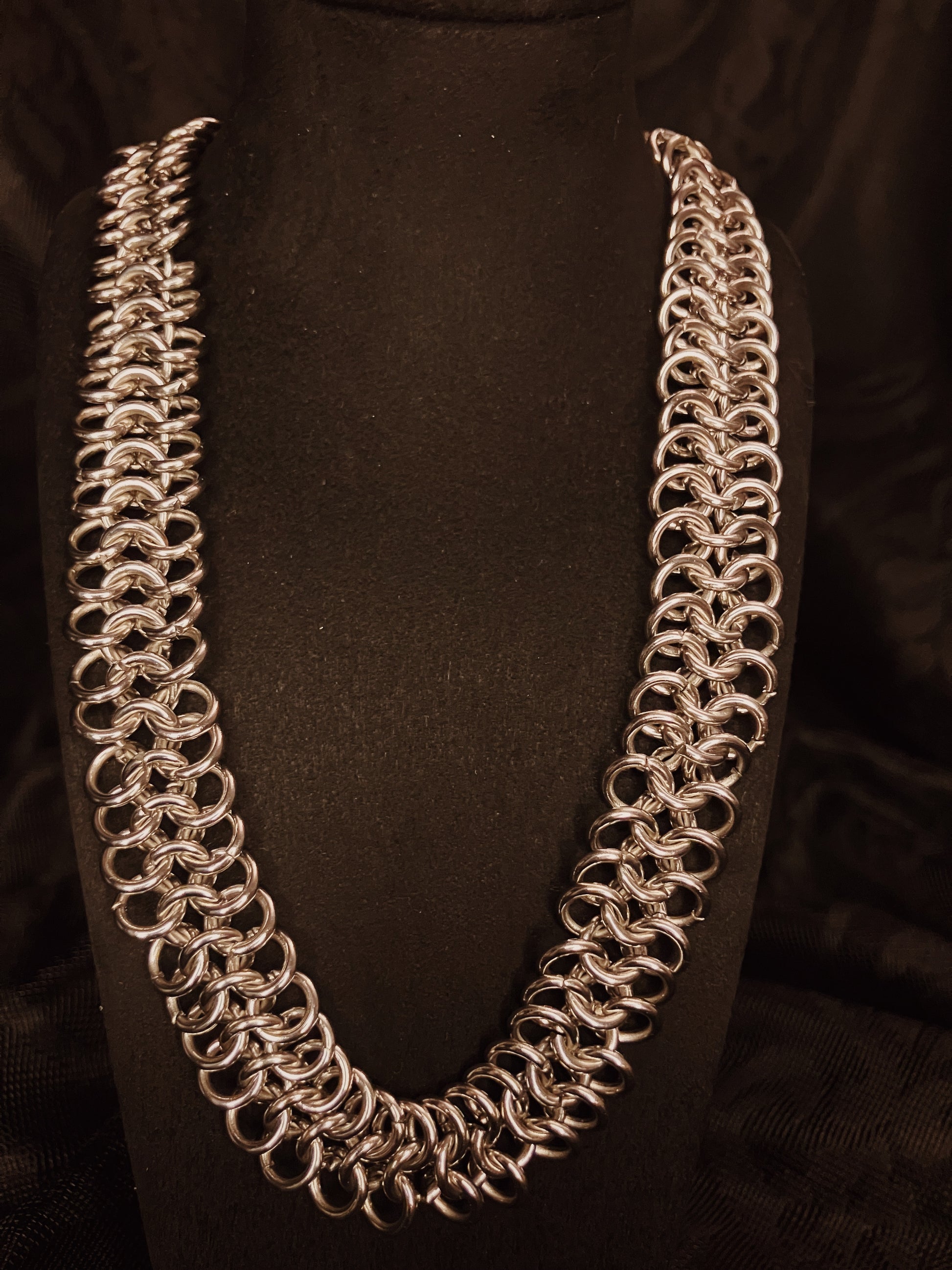 Chainmail necklace on a black background
