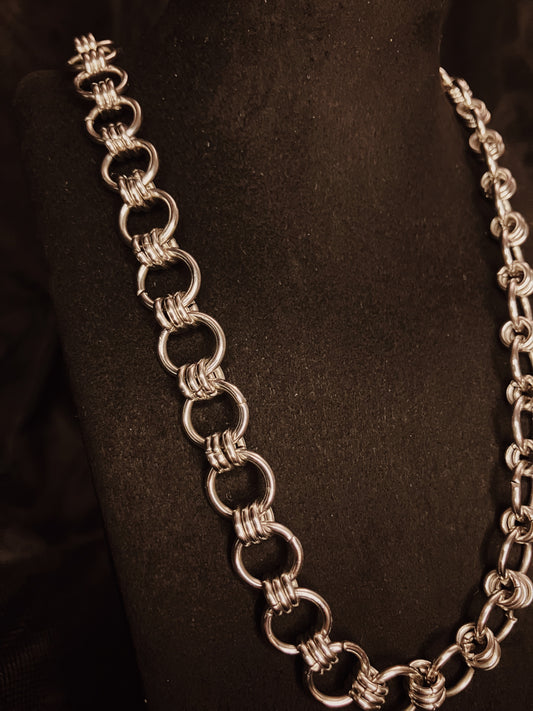 Silver chain necklace on a black background
