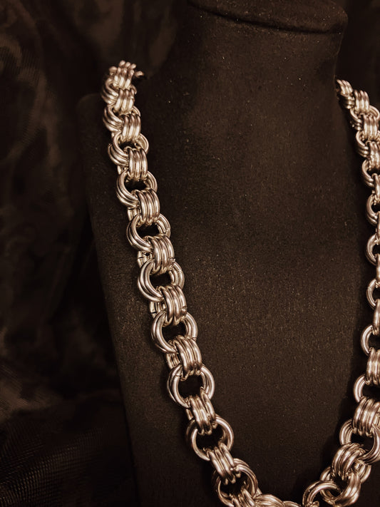 Silver chain necklace on a black background